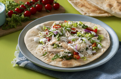 chicken-shawarma-with-jasmine-rice-served-over-a-pita-bread-with-tomatoes-and-red-onion